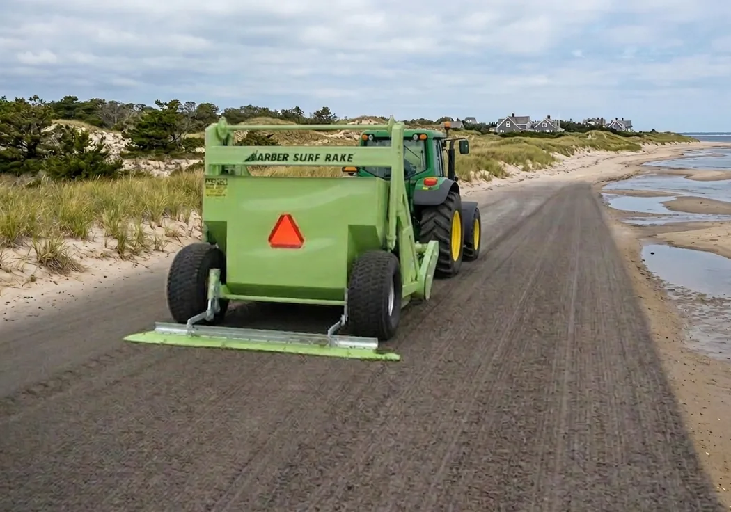 Tractor-towed surf rake grooming a Cape Cod beach