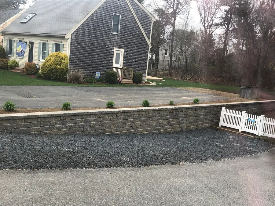 Segmental block retaining wall installed along a Cape Cod driveway