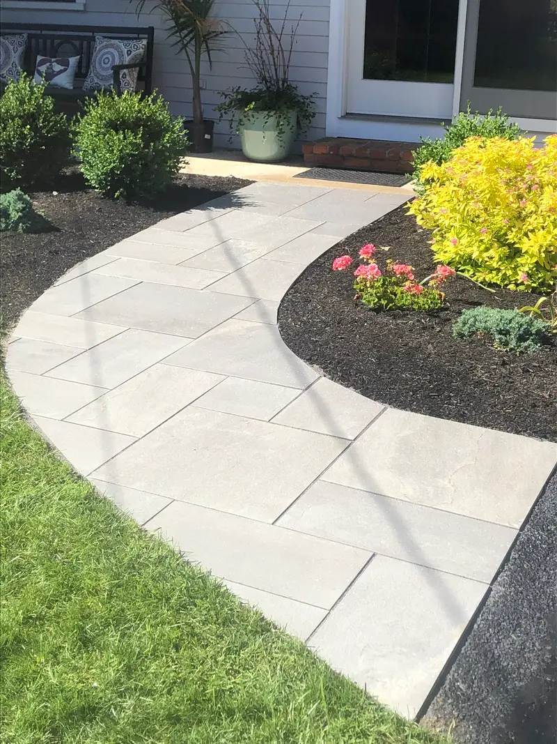 Curved bluestone walkway through planting beds on Cape Cod