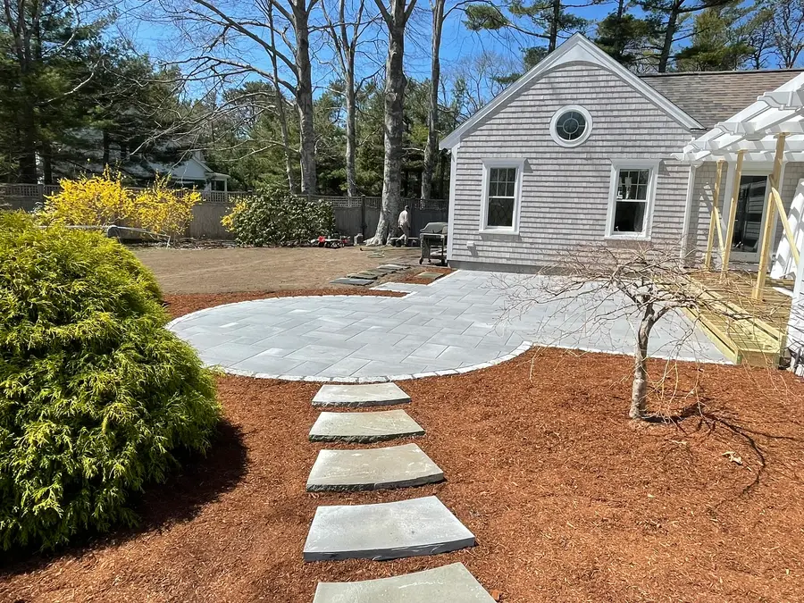 Bluestone stepping stone path leading to a circular patio on Cape Cod