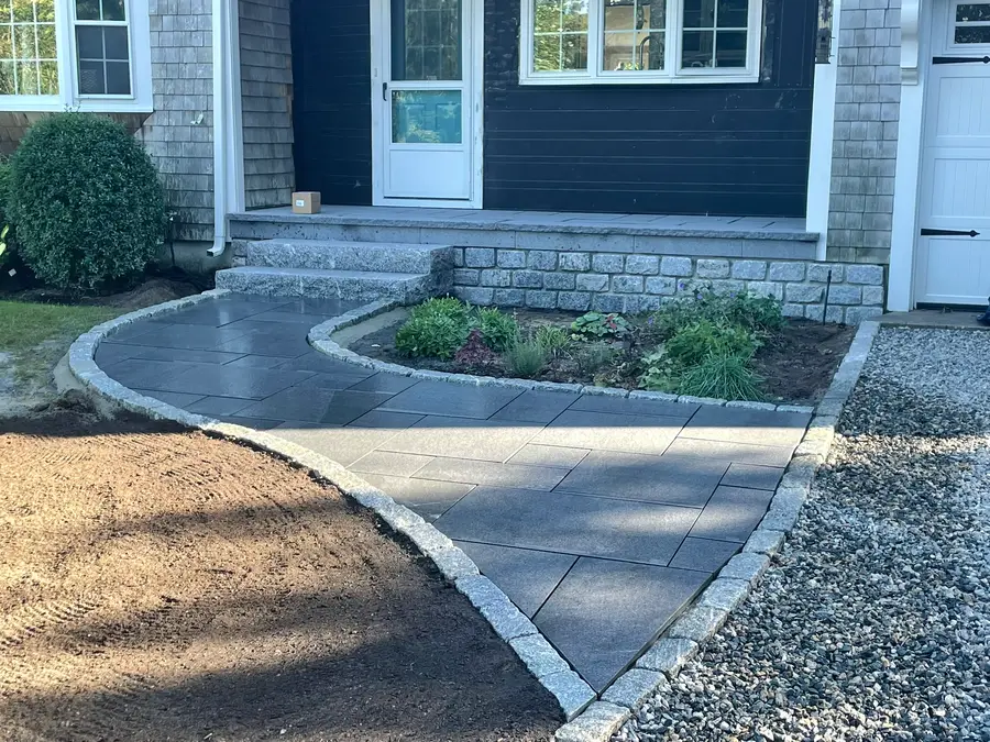 Bluestone walkway with granite curbing and stone retaining wall on Cape Cod