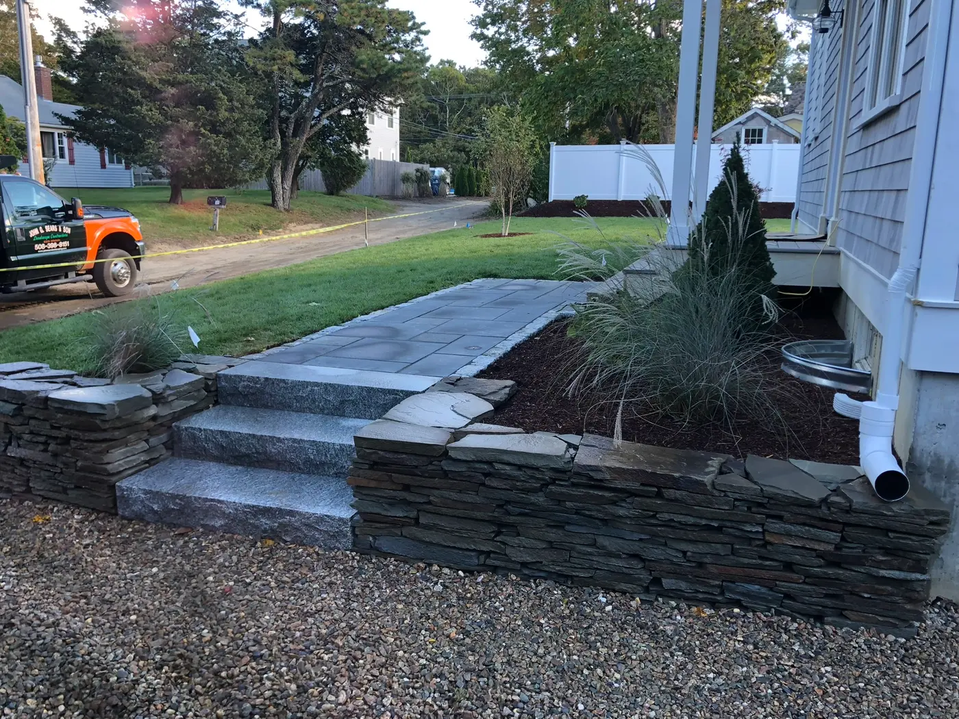 Stone retaining wall, granite steps, and bluestone patio built by the John G. Sears & Son crew on Cape Cod