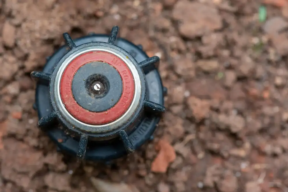 Close-up of an MP Rotator sprinkler nozzle during an irrigation repair